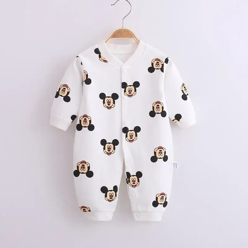 Newborn baby in waffle knit footed romper with hat
