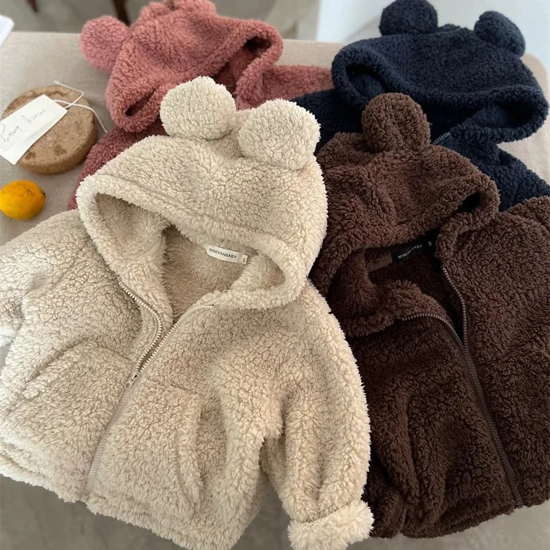 Child wearing plush hooded velvet jacket
